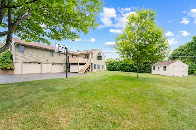223 Beach Rd, Wolcott, CT 06716 - view of green lawn featuring an attached garage, concrete driveway, stairway, and a deck