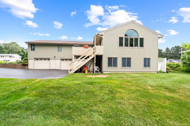 223 Beach Rd, Wolcott, CT 06716 - back of house featuring stairway, an attached garage, driveway, and a yard
