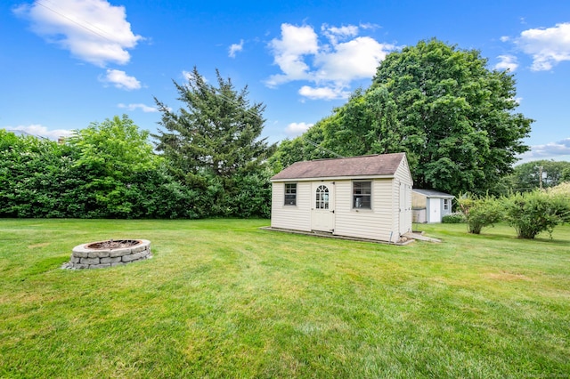 223 Beach Rd, Wolcott, CT 06716 - view of green lawn featuring a fire pit and a storage unit