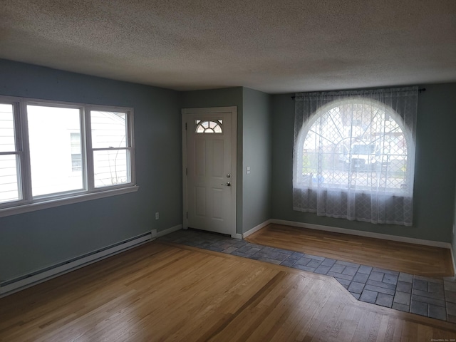 66 Macnamara St, Waterbury, CT 06708 - foyer entrance with a baseboard radiator, wood finished floors, a textured ceiling, and baseboards