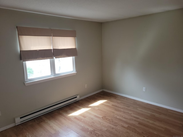 66 Macnamara St, Waterbury, CT 06708 - unfurnished room featuring a baseboard radiator, wood finished floors, and baseboards