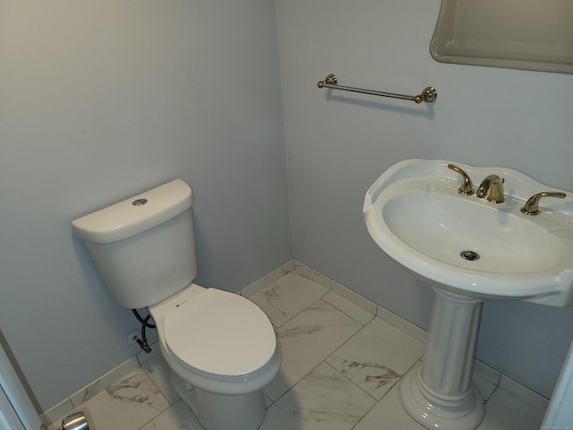 66 Macnamara St, Waterbury, CT 06708 - half bathroom featuring marble finish flooring, baseboards, and toilet