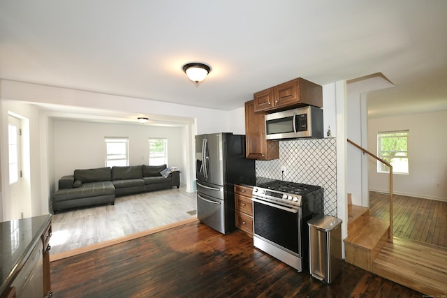 35 Church St, East Windsor, CT 06016 - kitchen with appliances with stainless steel finishes, dark countertops, dark wood-style flooring, and tasteful backsplash