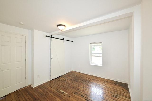 35 Church St, East Windsor, CT 06016 - empty room featuring a barn door, dark wood-style floors, baseboards, and a smoke detector