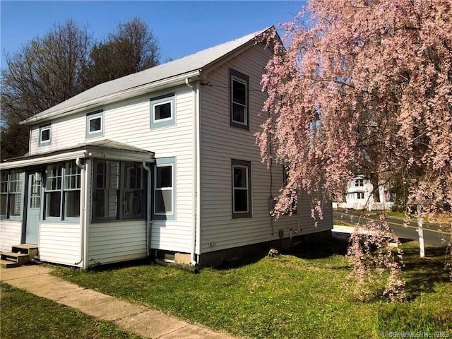 35 Church St, East Windsor, CT 06016 - view of home's exterior featuring a yard, entry steps, and a sunroom