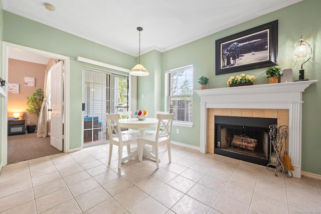 31 High St Unit 10103, East Hartford, CT 06118 - dining room with a tile fireplace, crown molding, light tile patterned flooring, and baseboards