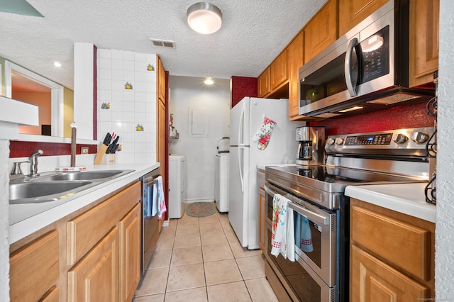 31 High St Unit 10103, East Hartford, CT 06118 - kitchen with stainless steel appliances, light countertops, light tile patterned flooring, a textured ceiling, and a sink