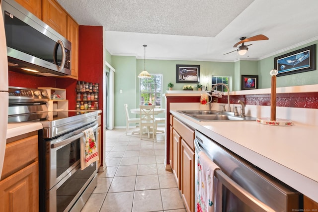 31 High St Unit 10103, East Hartford, CT 06118 - kitchen featuring appliances with stainless steel finishes, a sink, ornamental molding, light countertops, and light tile patterned floors