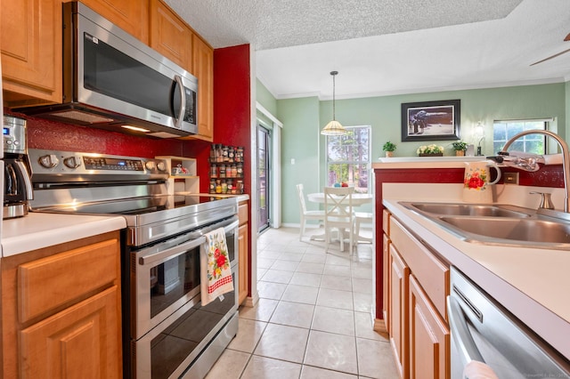 31 High St Unit 10103, East Hartford, CT 06118 - kitchen with appliances with stainless steel finishes, a sink, light countertops, light tile patterned floors, and a textured ceiling