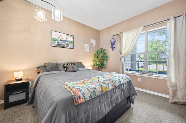 31 High St Unit 10103, East Hartford, CT 06118 - bedroom with baseboards, carpet floors, and a chandelier