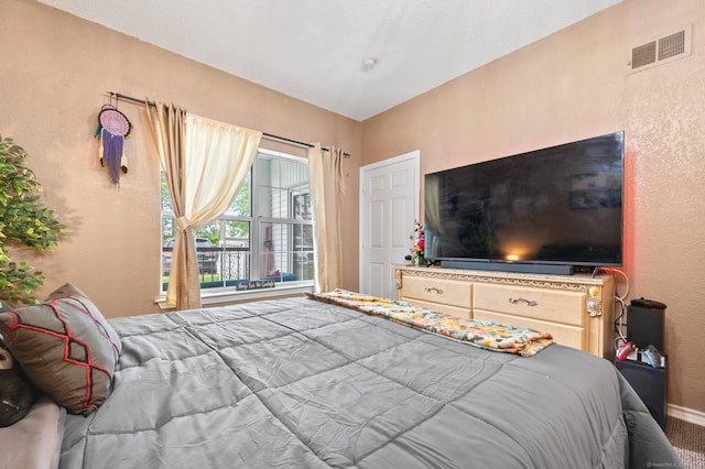 31 High St Unit 10103, East Hartford, CT 06118 - carpeted bedroom with a textured wall and baseboards