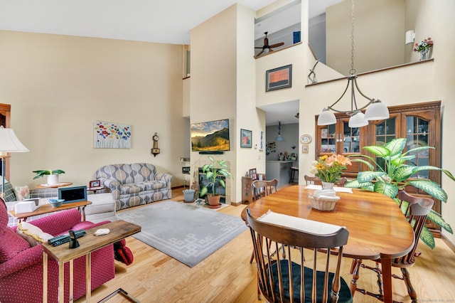 472 Carriage Dr Unit 472, Southington, CT 06489 - dining room featuring wood finished floors, a towering ceiling, a chandelier, and ceiling fan