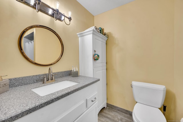 472 Carriage Dr Unit 472, Southington, CT 06489 - full bathroom with wood finished floors, toilet, vanity, and baseboards