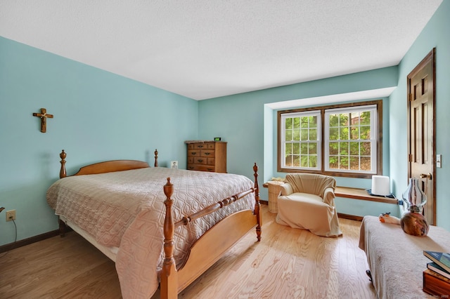 472 Carriage Dr Unit 472, Southington, CT 06489 - bedroom featuring wood finished floors, baseboards, and a textured ceiling