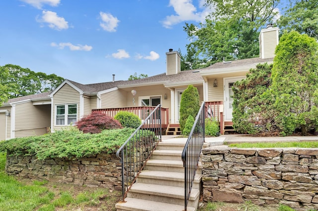 472 Carriage Dr Unit 472, Southington, CT 06489 - view of front of property with a chimney, a wooden deck, and stairway