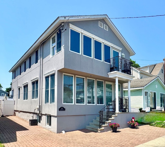 25 Milesfield Ave, Milford, CT 06460 - back of house with a balcony, stucco siding, and a patio area