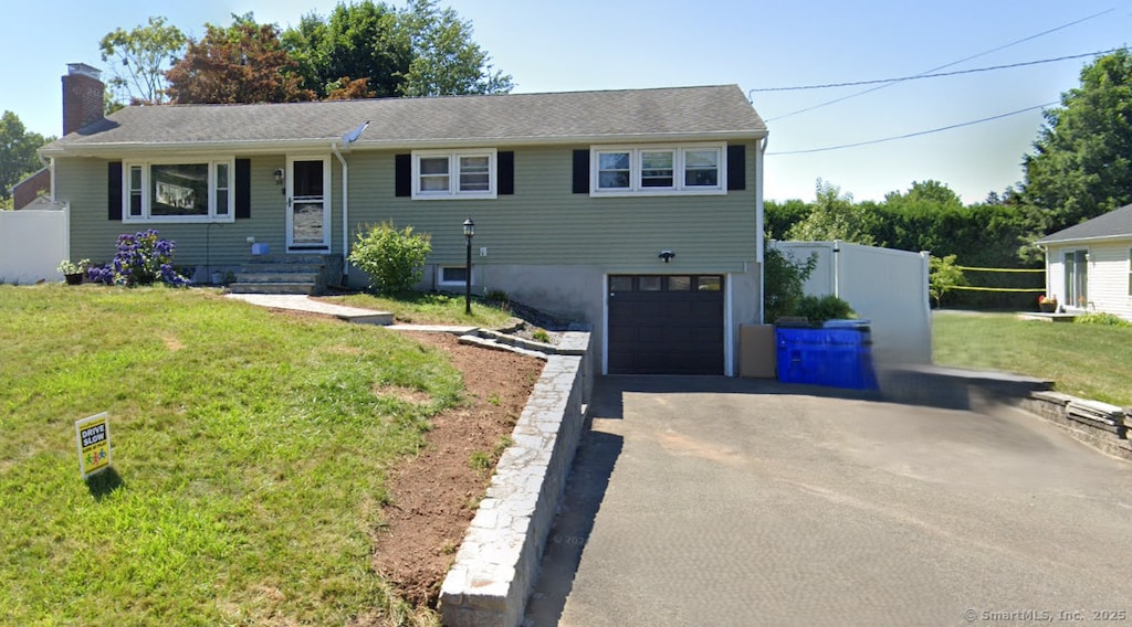 34 Fox Hill Rd, Wethersfield, CT 06109 - view of front of property with a chimney, driveway, and a garage