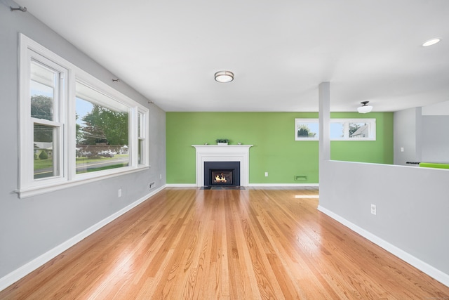 34 Fox Hill Rd, Wethersfield, CT 06109 - unfurnished living room with light wood finished floors, baseboards, and a fireplace with flush hearth
