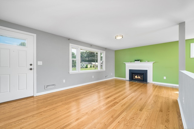 34 Fox Hill Rd, Wethersfield, CT 06109 - unfurnished living room featuring light wood finished floors, a fireplace with flush hearth, and baseboards