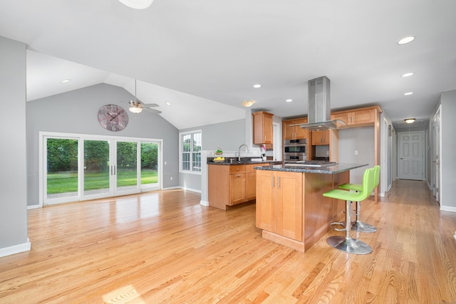 34 Fox Hill Rd, Wethersfield, CT 06109 - kitchen with island exhaust hood, a ceiling fan, light wood-type flooring, double oven, and recessed lighting