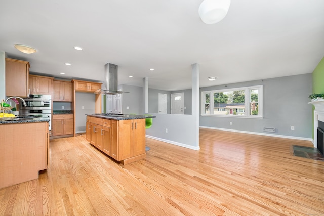 34 Fox Hill Rd, Wethersfield, CT 06109 - kitchen with island range hood, appliances with stainless steel finishes, light wood finished floors, open floor plan, and a center island