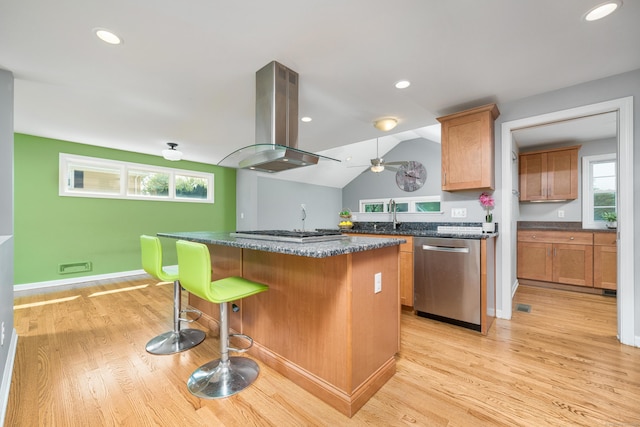 34 Fox Hill Rd, Wethersfield, CT 06109 - kitchen with appliances with stainless steel finishes, island exhaust hood, light wood finished floors, a breakfast bar area, and recessed lighting