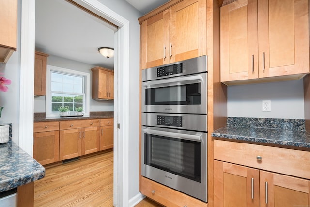 34 Fox Hill Rd, Wethersfield, CT 06109 - kitchen with double oven, light wood-style flooring, and dark stone counters