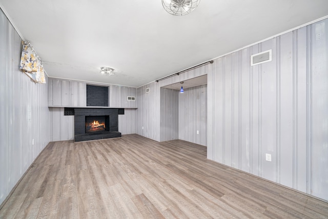 34 Fox Hill Rd, Wethersfield, CT 06109 - unfurnished living room featuring a brick fireplace and wood finished floors