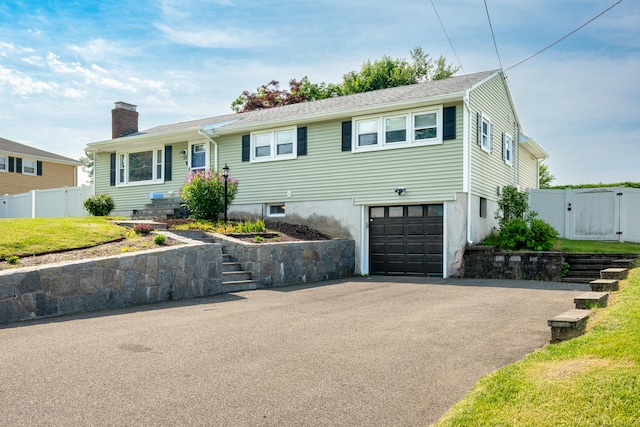 34 Fox Hill Rd, Wethersfield, CT 06109 - single story home with a garage, a chimney, asphalt driveway, and a gate