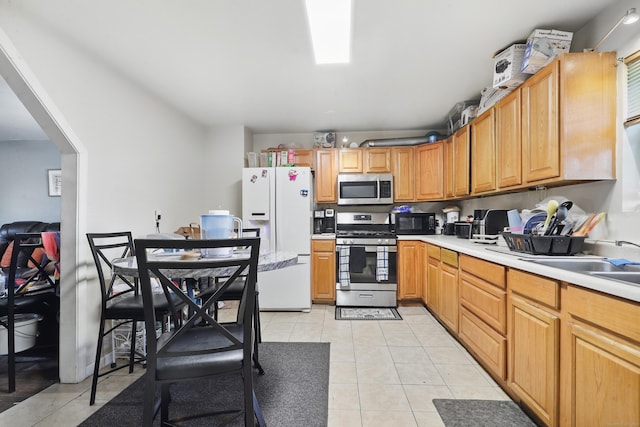 241 Wallace St, New Haven, CT 06511 - kitchen with appliances with stainless steel finishes, light tile patterned floors, light countertops, and a sink