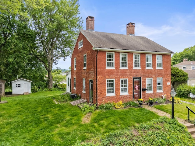 517 Wolcott Hill Rd, Wethersfield, CT 06109 - colonial-style house with a chimney, brick siding, a front yard, and a shingled roof