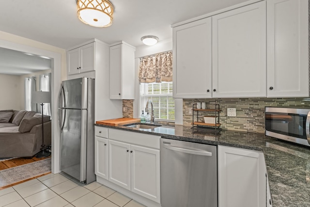 517 Wolcott Hill Rd, Wethersfield, CT 06109 - kitchen featuring stainless steel appliances, a sink, white cabinetry, backsplash, and open floor plan