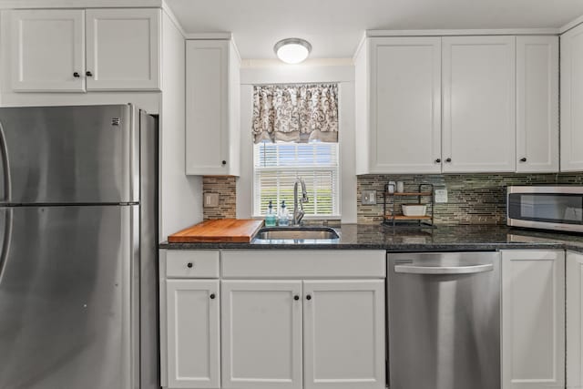 517 Wolcott Hill Rd, Wethersfield, CT 06109 - kitchen featuring appliances with stainless steel finishes, a sink, backsplash, and white cabinetry