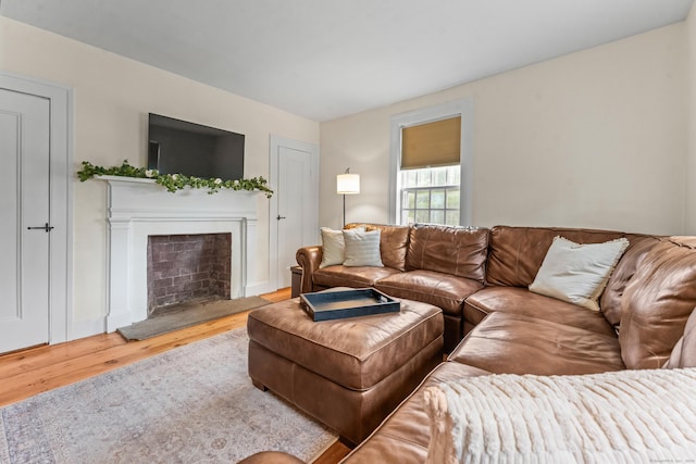 517 Wolcott Hill Rd, Wethersfield, CT 06109 - living area with wood finished floors and a fireplace with raised hearth