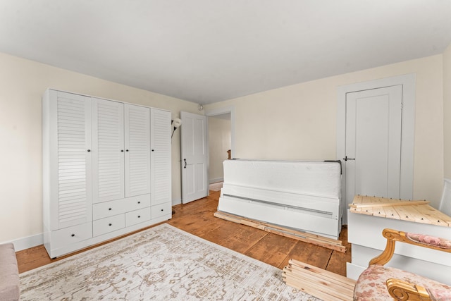 517 Wolcott Hill Rd, Wethersfield, CT 06109 - bedroom featuring wood finished floors, baseboards, and a closet
