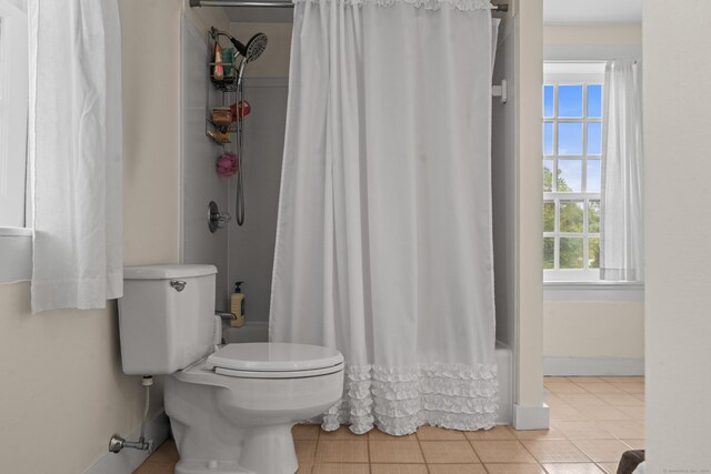 517 Wolcott Hill Rd, Wethersfield, CT 06109 - bathroom with healthy amount of natural light, toilet, tile patterned floors, and shower / bath combo
