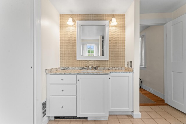 517 Wolcott Hill Rd, Wethersfield, CT 06109 - bathroom with vanity, backsplash, and tile patterned flooring