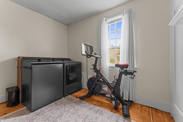 517 Wolcott Hill Rd, Wethersfield, CT 06109 - workout room with washing machine and clothes dryer, baseboards, and wood finished floors