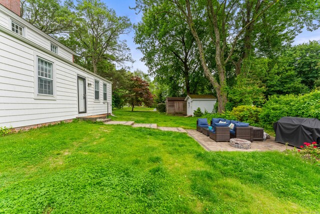 517 Wolcott Hill Rd, Wethersfield, CT 06109 - view of green lawn featuring a patio and an outdoor living space with a fire pit