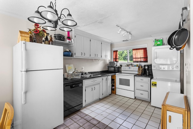 32 Anton Rd Apt C, Mansfield, CT 06268 - kitchen with black appliances, estacked washer and dryer, crown molding, dark countertops, and light tile patterned floors