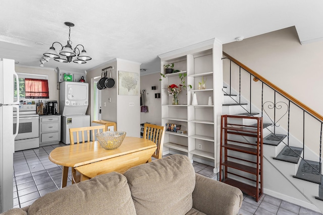 32 Anton Rd Apt C, Mansfield, CT 06268 - dining area featuring stacked washer / dryer, light tile patterned flooring, a chandelier, stairs, and ornamental molding