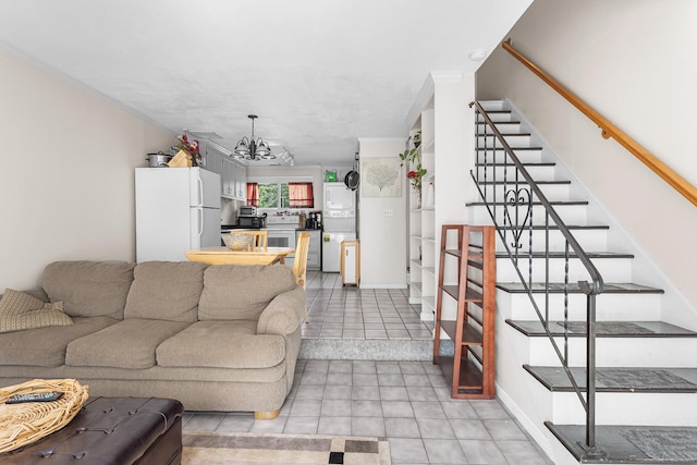 32 Anton Rd Apt C, Mansfield, CT 06268 - living room featuring stairs, a chandelier, light tile patterned flooring, and ornamental molding