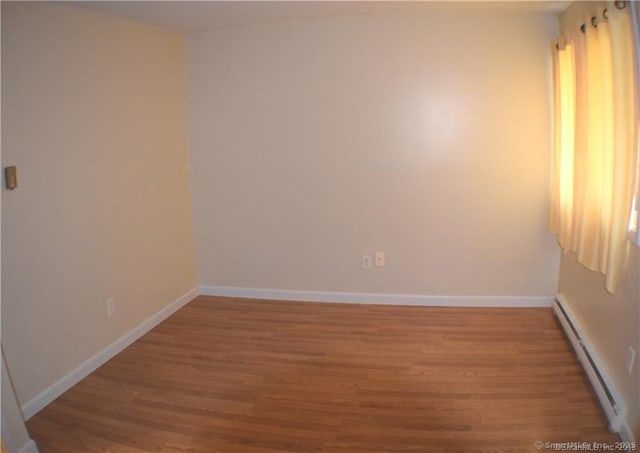 32 Anton Rd Apt C, Mansfield, CT 06268 - empty room featuring a baseboard radiator, wood finished floors, and baseboards