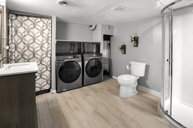 104 Bay Ave, New Britain, CT 06053 - full bathroom with washer and dryer, vanity, a shower stall, wood finished floors, and toilet