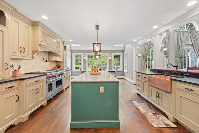 16 Oak Blf, Avon, CT 06001 - kitchen with cream cabinetry, double oven range, wood finished floors, backsplash, and a center island