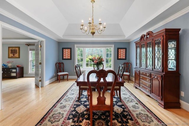 16 Oak Blf, Avon, CT 06001 - dining room featuring a raised ceiling, a chandelier, plenty of natural light, light wood-style floors, and crown molding