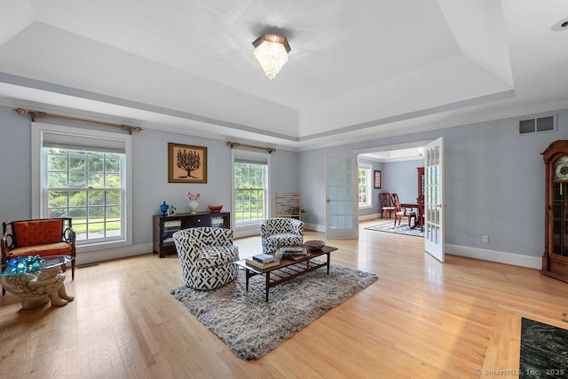 16 Oak Blf, Avon, CT 06001 - living room featuring a tray ceiling, french doors, light wood-style flooring, and ornamental molding