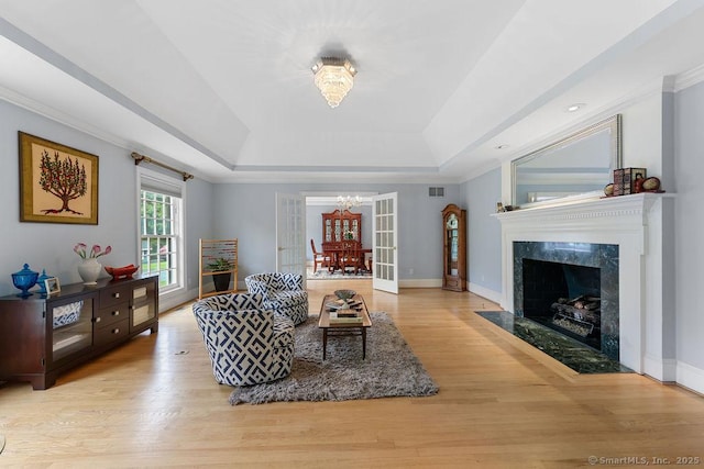 16 Oak Blf, Avon, CT 06001 - living area with a chandelier, a raised ceiling, wood finished floors, ornamental molding, and a fireplace