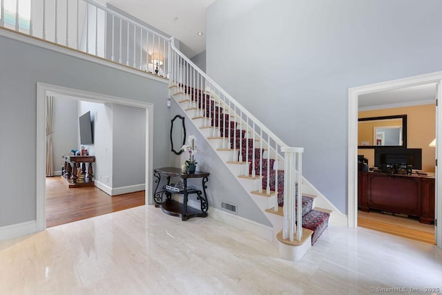 16 Oak Blf, Avon, CT 06001 - stairway with a high ceiling, wood finished floors, and ornamental molding