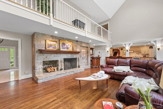 16 Oak Blf, Avon, CT 06001 - living area featuring wood finished floors, a high ceiling, a stone fireplace, and recessed lighting
